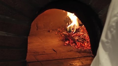 crispy pizza baking in a wood fired stone oven