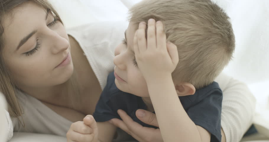 Beautiful young mother with her child under the sheets, Portrait family mother and son, Slow motion, 4K | Shutterstock HD Video #1006877737