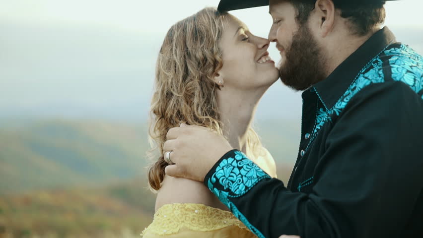 Fall on Max Patch MountainMax Patch MountainAppalachian Mountains, Tennessee & North Carolina, young couple, woman in yellow dress with cowboy in hat