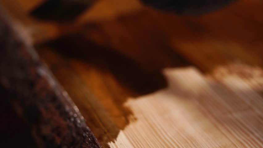close up shot of the homemade table, which is covered with a protective varnish in the carpenter's shop, the man paints the paint on a wooden surface Royalty-Free Stock Footage #1006896076