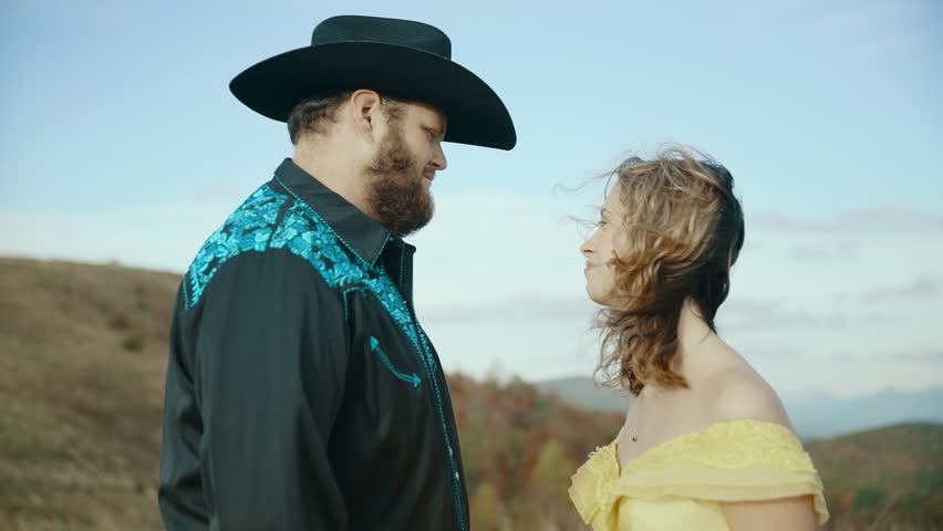 Fall on Max Patch MountainMax Patch MountainAppalachian Mountains, Tennessee & North Carolina, young couple, woman in yellow dress with cowboy in hat