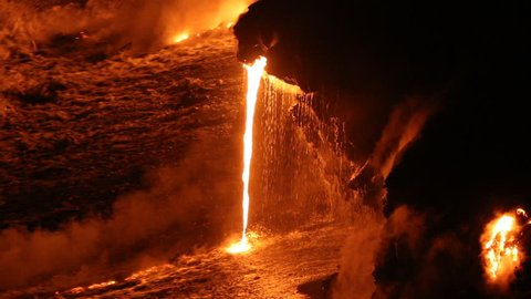 Lava running in the ocean from volcanic lava eruption on Big Island Hawaii. Lava stream flowing in Pacific Ocean from Kilauea volcano by Hawaii volcanoes national park, USA. Night shot 59.94 FPS.