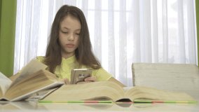 girl does homework with a smartphone stock footage video