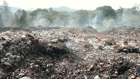 Large garbage dump waste with smoke