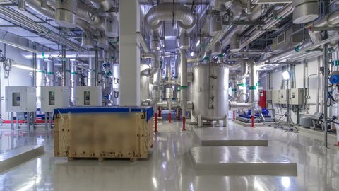Equipment, cables and piping as found inside of industrial chiller plant room timelapse hyperlapse. Part of data center