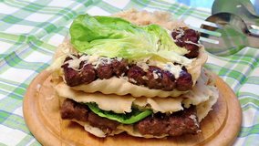 Juicy hamburger of pork and beef meat with mayonnaise and green salad, Slow Motion Video Clip