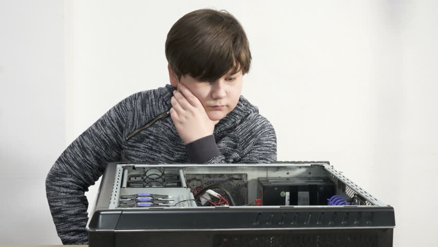 A Close up Geek child boy work with a screwdriver, installing Graphic Card hardware. Royalty-Free Stock Footage #1006923862