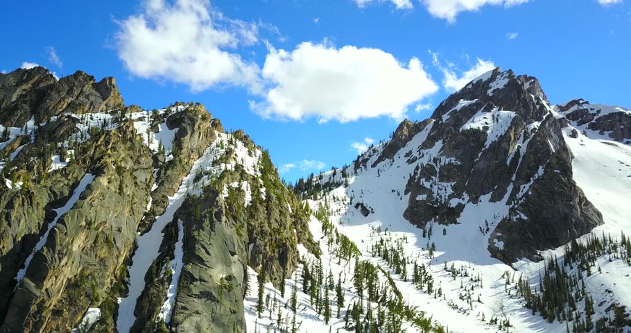 Sawtooth Mountains Idaho - Drone Aerial View Of Jagged Snowy Peaks With Pine Trees On The Slopes