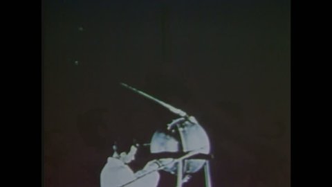1960s: Scientist operates Sputnik 1 satellite. Space rocket takes off, smoke. Laika space dog. Space rocket flies in the sky.