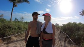 Couple of joggers walking back from the beach