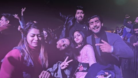 A group of friends dancing at live music concert, New Delhi, India ( January 2018)