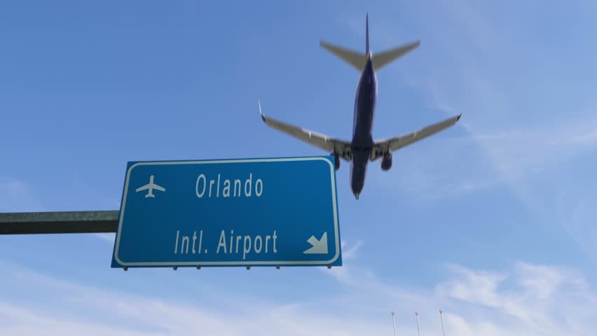 Orlando airport sign airplane passing overhead
