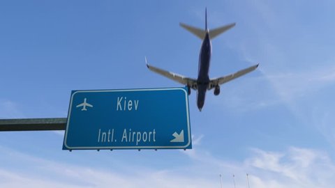 kiev airport sign airplane passing overhead