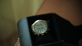 Gentleman accessory. Clip. Close up men's hand taking watch from the box. Concept of business dress