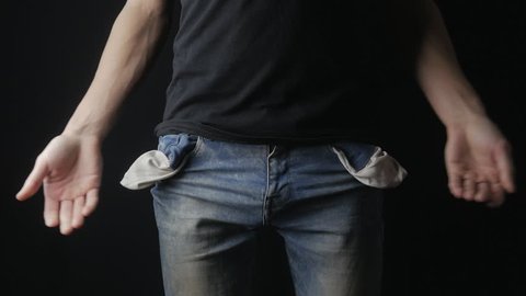 Man Turns the Empty Pockets of His Jeans. No Money