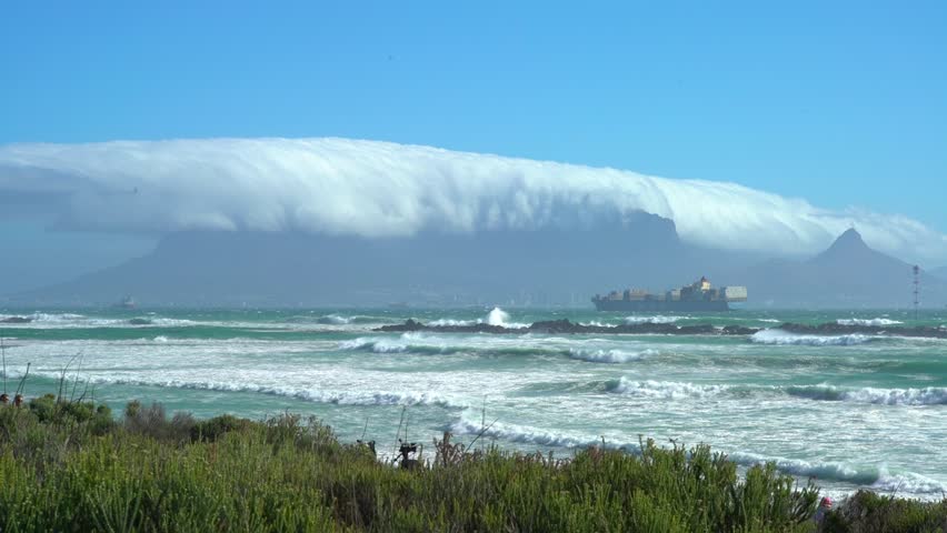 Time lapse photography table cloth clouds over Table Mountain and a big ship in the storm in Cape Town, South Africa
