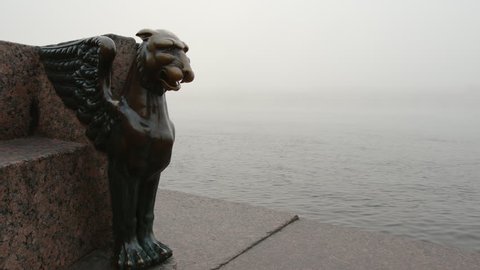 ST. PETERSBURG, RUSSIA - SEPTEMBER 18, 2017: Bronze Griffon and the Neva river in a fog