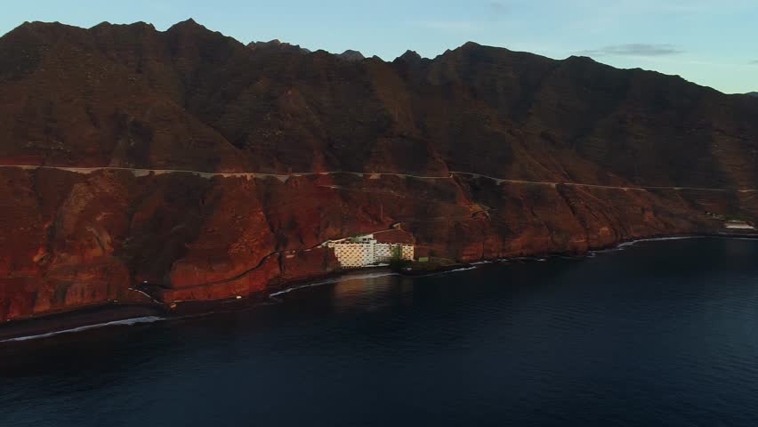 Flight over a seashore at sunrise
