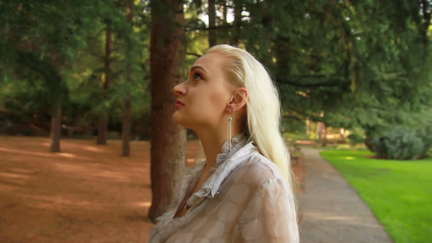young woman looking at trees