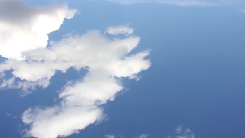 Air plane window view time lapse clouds & blue sunny sky, Loop of white clouds over blue sky with sun Rays, Aerial view, drone shooting clouds motion time, nature blue sky & white cleat weather. UHD.