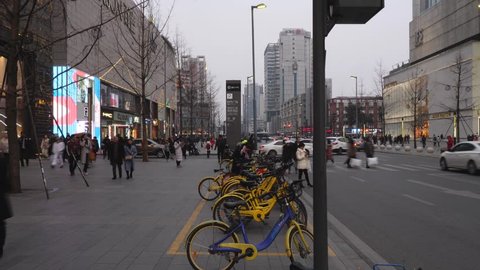 Chengdu,Sichuna China, Jan,31,2018: time lapse of people walking  at IFS  around Chunxiroad with people use Shared bike downtown Chengdu ,Sichuan China