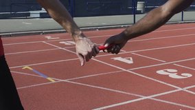 Closeup view of participant handing off baton to next runner, world championship - Powered by Shutterstock - Get 15% off with code: PIKWIZARD15