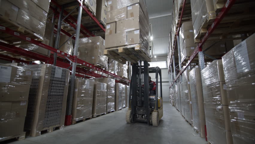 Forklift Trucks load Pallets with Cardboard Boxes at modern warehouse Royalty-Free Stock Footage #1006976716