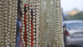 flower market in india, white lily buds garlands for sale in the flower market moving in a steel ring clock wise and anti clock wise, flowers on display in the market   - Powered by Shutterstock - Get 15% off with code: PIKWIZARD15