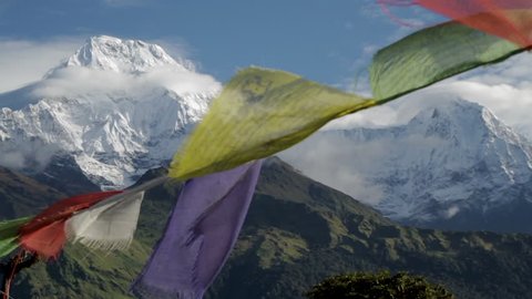 Nepalese Prayer Flags Flapping in Wind in Front of Himalayan Mountains.