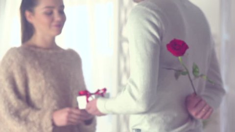 Valentine Gift. Happy Young Couple with Valentine's Day or birthday Present. Happy Man giving a gift to his Girlfriend. Love concept. Holiday. Slow motion 240 fps. 4K UHD video