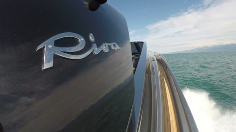 VIAREGGIO – MAY 12: Riva logo on a fancy luxury yacht navigating fast on May 12, 2017, in Viareggio, Italy