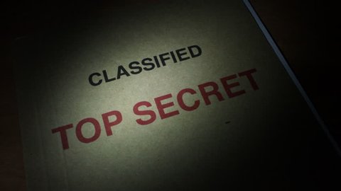 Spying and finding a Top Secret File under torch light. Classified documents.