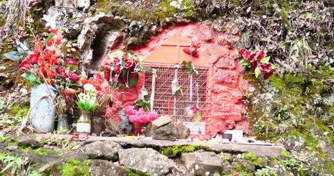 Indigenous altar by the side of a mountain colorful ribbons  ancestral ceremony memorial 