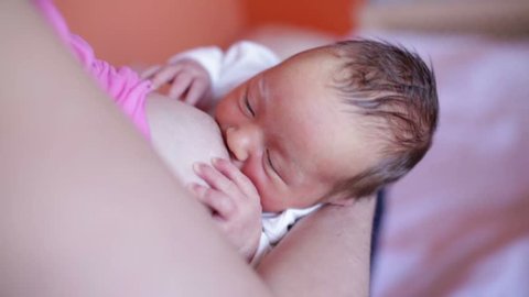 Breast feeding, breastfeeding concept. Young happy Mother feeding her Newborn baby. mother breastfeeding, hugging and kissing her hew born child. Lactation infant.Breast-feeding .newborn baby. 