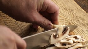 Slicing fresh champignons for the sauce. Video