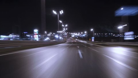 Time lapse of driving a car in the city at night time. POV. Hyper laps in the evening downtown. Timelapse.