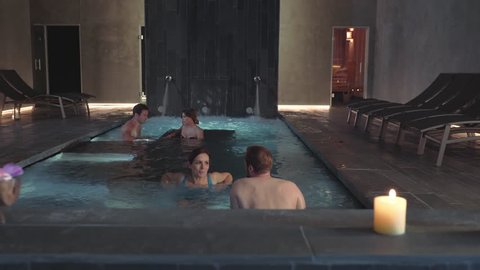 Happy Relaxed Couples Enjoying Spa Pool