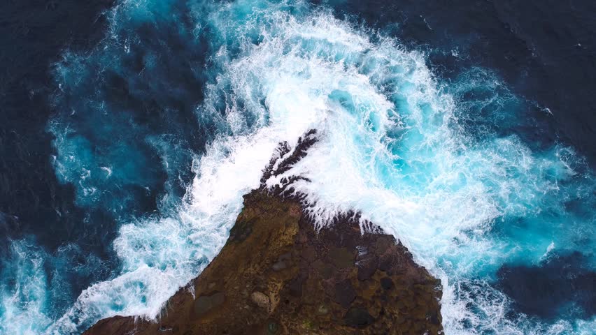 Aerial view by drone 4k camera. Ocean with waves and rocky cliff.  Nusa Penida, Indonesia. zoom in