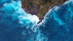 Aerial view by drone 4k camera. Ocean with waves and rocky cliff. Nusa Penida, Indonesia. 