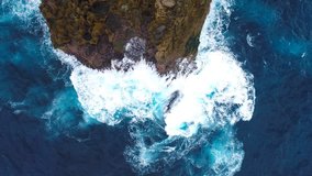 Aerial view by drone 4k camera. Ocean with waves and rocky cliff. Nusa Penida, Indonesia. zoom in