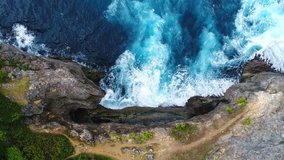 Aerial view by drone 4k camera. Ocean with waves and rocky cliff.  Nusa Penida, Indonesia. zoom in