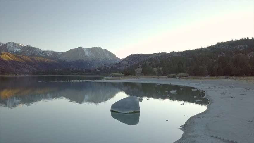 Aerial Reveal Lake June mirror reflection of Snow Mountains, Mono County - California