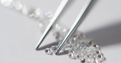 A goldsmith sorts precious stones of high value, catalogs them to make precious jewels in diamond. Concept of: jewelry, luxury, goldsmith, diamonds, brilliance.