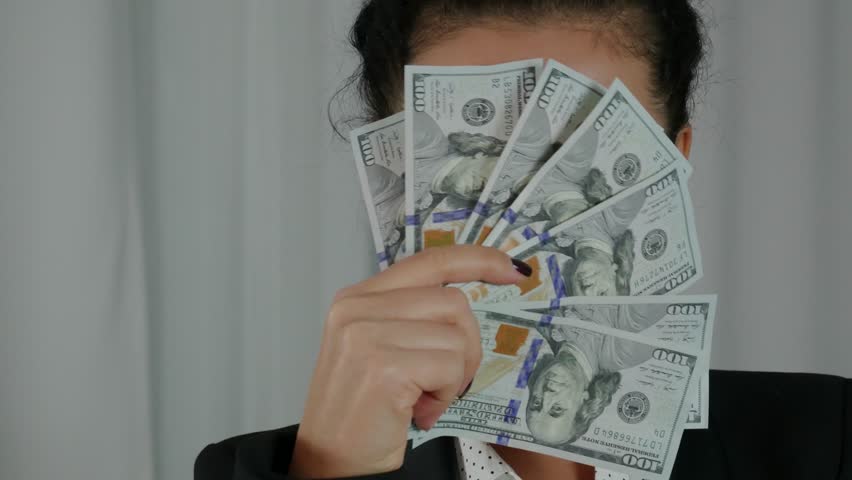 Cute Business Woman Displaying a Spread of Cash. Successfuly girl wins bucks in lottery. Concept of money health, abundance, new idea, successful. Close-up Royalty-Free Stock Footage #1007053843