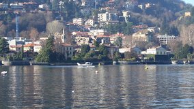 Seaplane aircraft floats on the water and takes off from Water Aerodrome of Como lake, Lombardy, Italy. Since 1913 Como is home to the only seaplane school in Europe