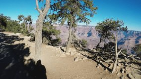 Grand Canyon AZ/USA: December 30, 2017- Bicycle rider's viewpoint with rolling pan of the Grand Canyon in Arizona. Clip reveals view of the canyon's edge along a bike path.