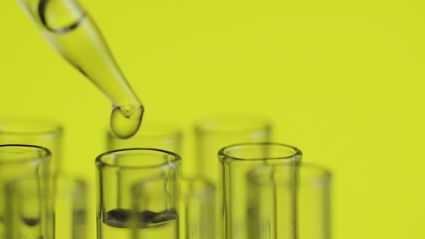 At laboratory scientist working with a pipette analyzes and extract the DNA or molecules in the test tubes.on yellow background | Shutterstock HD Video #1007061022