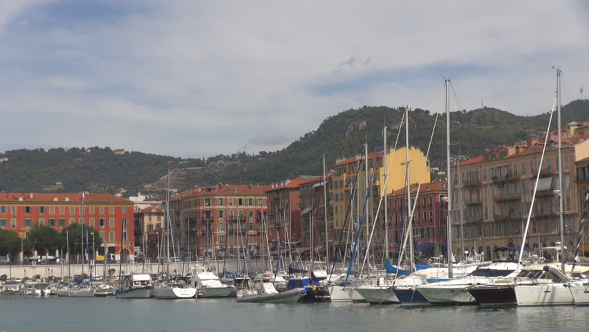 Beautiful Nice city port by day, traditional building architecture and yacht in bay