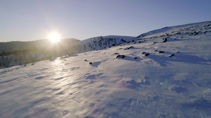 Frosten hill landscape with sun light. Moving backwards dolly shot