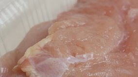 Package with poultry meat close-up 4K 2160p 30fps UltraHD video - Panning over frozen chicken breasts in a box 3840X2160 UHD footage